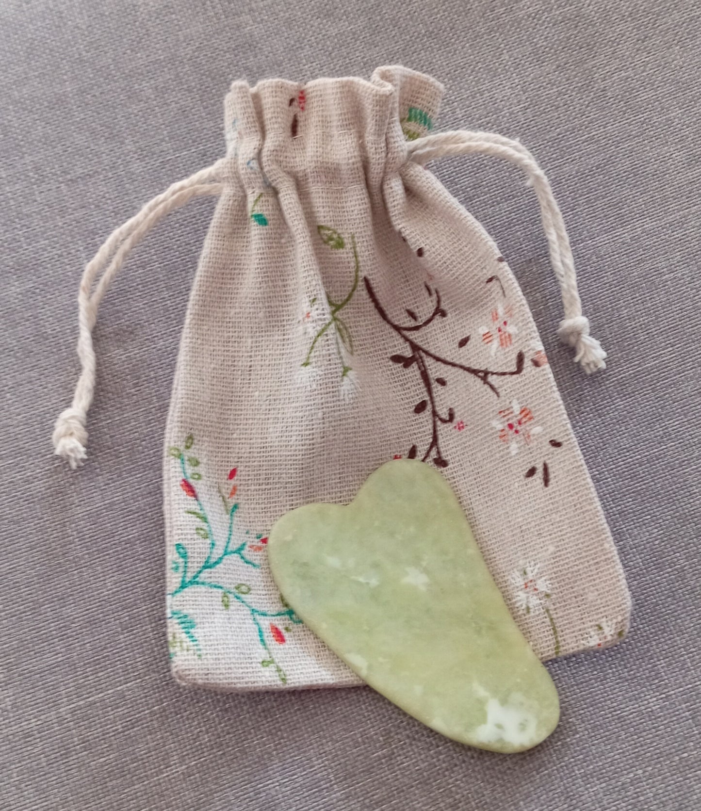 Gua sha facial tool in hessian wildflower bag