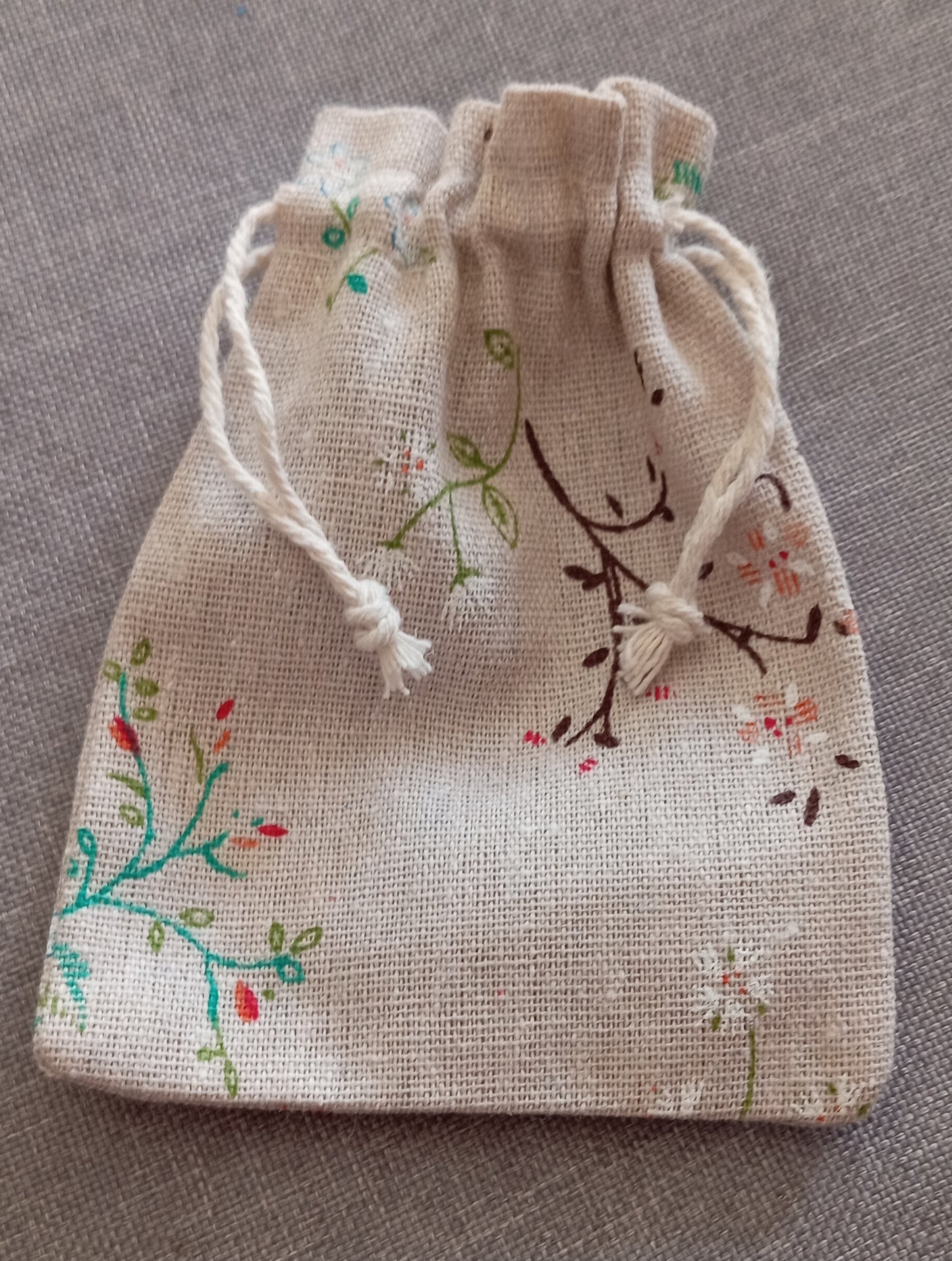 Gua sha facial tool in hessian wildflower bag