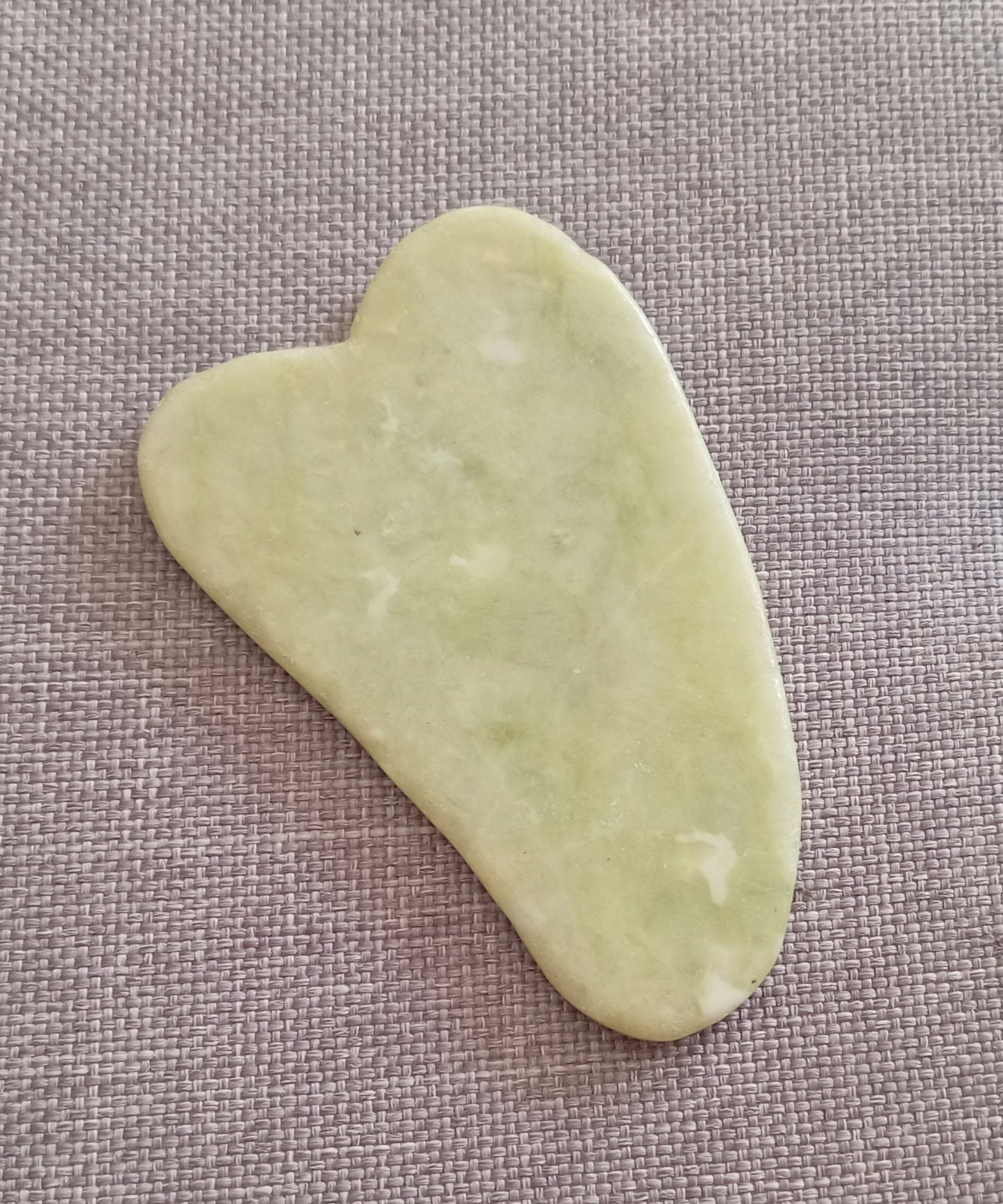 Gua sha facial tool in hessian wildflower bag